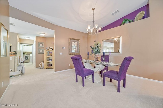 carpeted dining area featuring washer / clothes dryer, lofted ceiling, and a notable chandelier