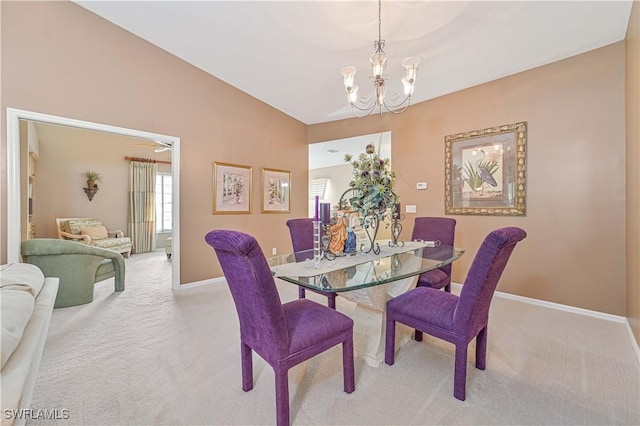 dining space featuring vaulted ceiling, light colored carpet, and an inviting chandelier