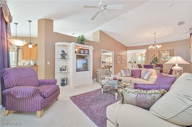 carpeted living room featuring ceiling fan with notable chandelier and vaulted ceiling