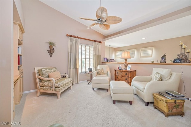 sitting room with lofted ceiling, light carpet, and ceiling fan