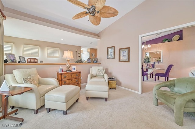 living area featuring ceiling fan with notable chandelier, light colored carpet, a healthy amount of sunlight, and vaulted ceiling