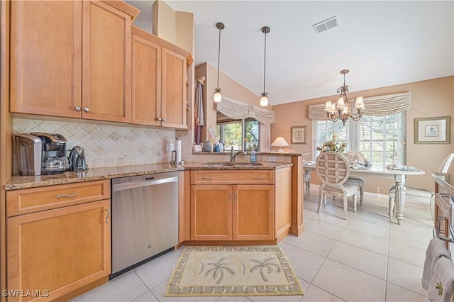 kitchen featuring decorative light fixtures, dishwasher, sink, light tile patterned floors, and light stone counters