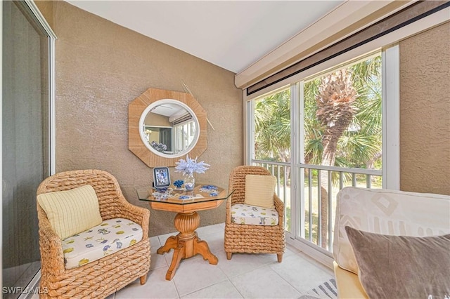 living area with a wealth of natural light and light tile patterned flooring