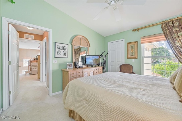 carpeted bedroom featuring lofted ceiling, multiple windows, a closet, and ceiling fan