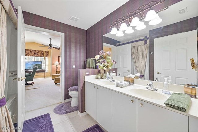 bathroom featuring vaulted ceiling, tile patterned flooring, vanity, ceiling fan, and toilet