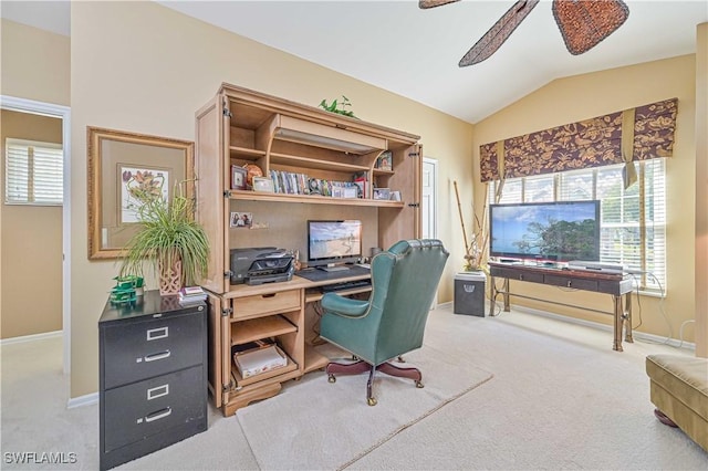 carpeted office space featuring ceiling fan and vaulted ceiling