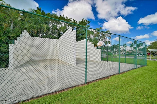 view of basketball court with a lawn