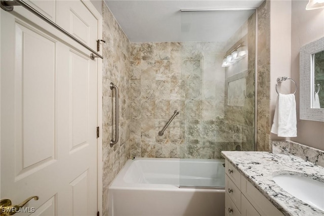 bathroom featuring vanity and tiled shower / bath