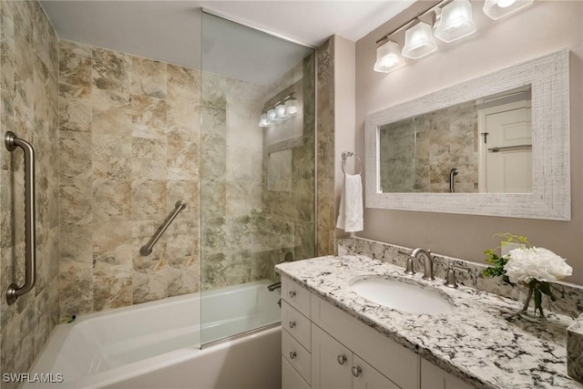 bathroom with vanity and tiled shower / bath combo