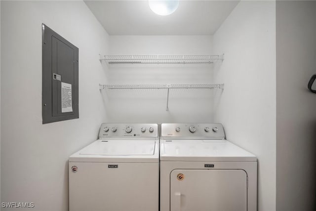 washroom featuring electric panel and washing machine and clothes dryer