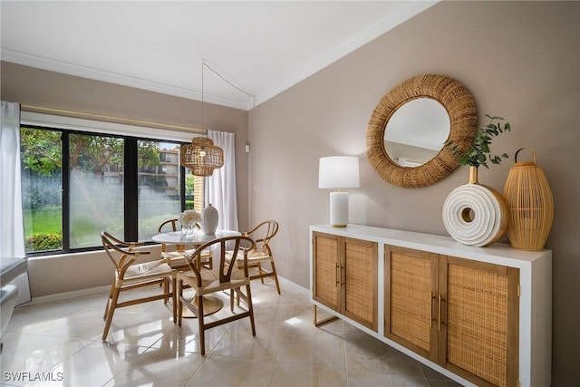 tiled dining area with crown molding, lofted ceiling, and a wealth of natural light