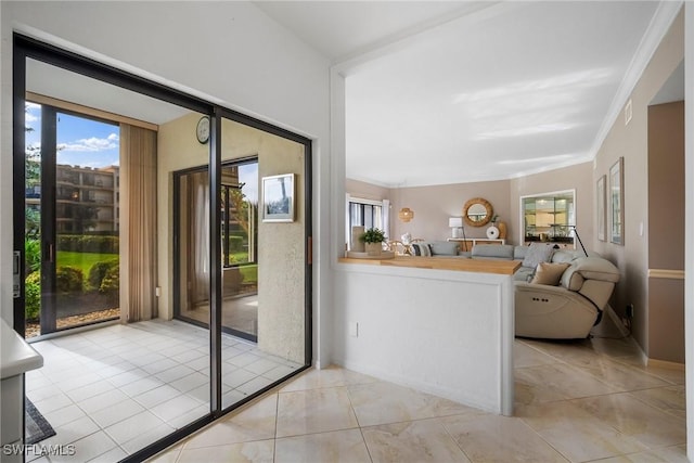 interior space featuring light tile patterned flooring and crown molding