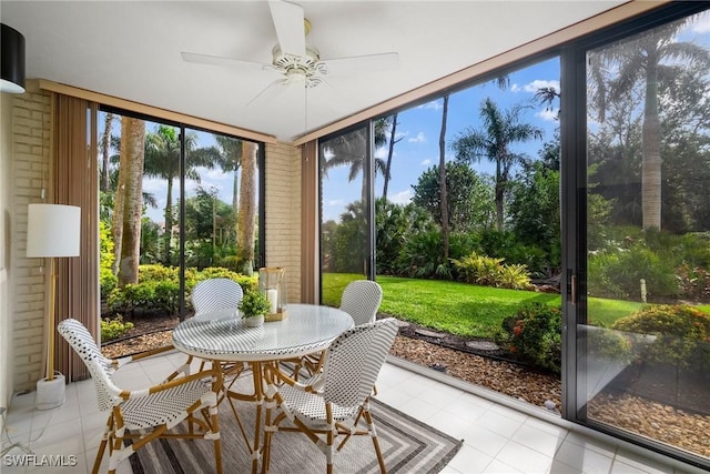 sunroom / solarium featuring a wealth of natural light and ceiling fan