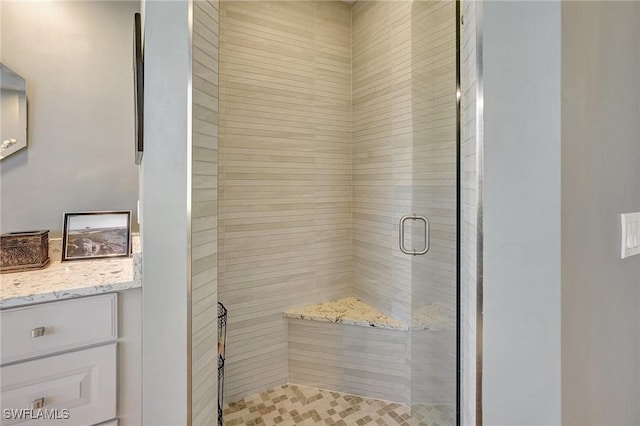 bathroom with vanity and a shower with door