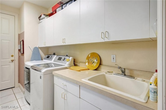 clothes washing area featuring cabinets, light tile patterned flooring, sink, and independent washer and dryer