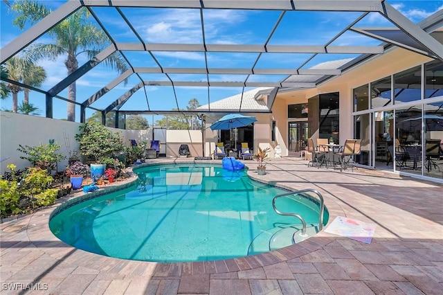 view of pool with a lanai and a patio area