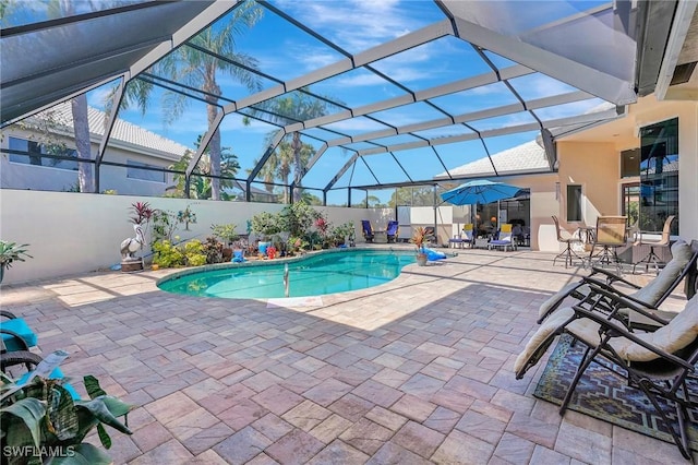 view of pool featuring a patio and glass enclosure