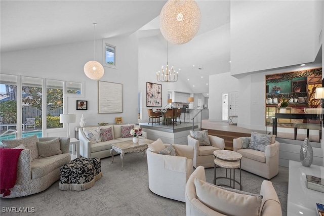 living room with high vaulted ceiling, a wealth of natural light, and a chandelier