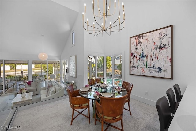 dining space featuring a healthy amount of sunlight and a high ceiling