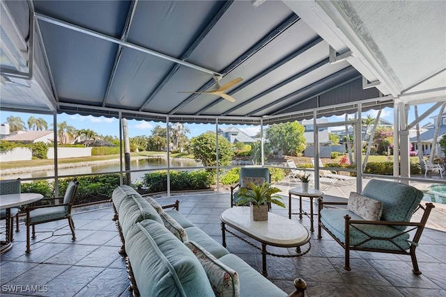 sunroom featuring vaulted ceiling and a water view