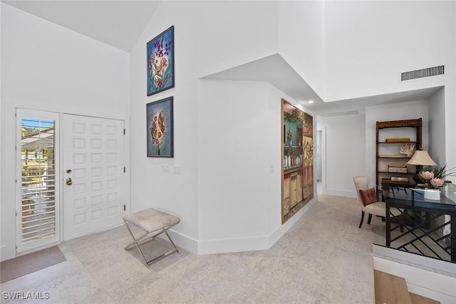 entryway featuring high vaulted ceiling