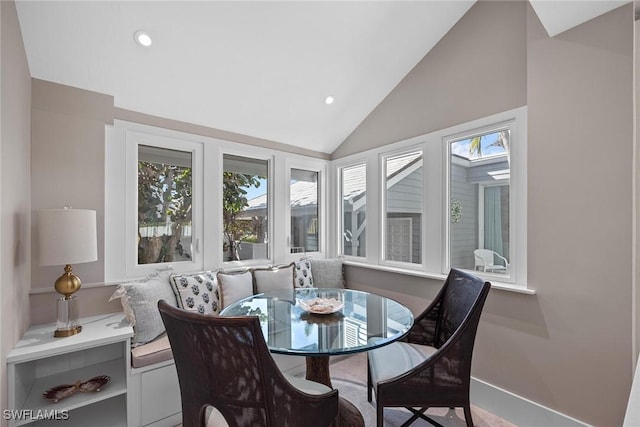 dining room featuring lofted ceiling