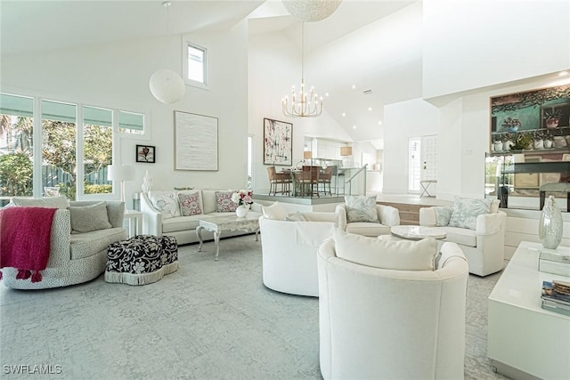 living room featuring high vaulted ceiling and a notable chandelier