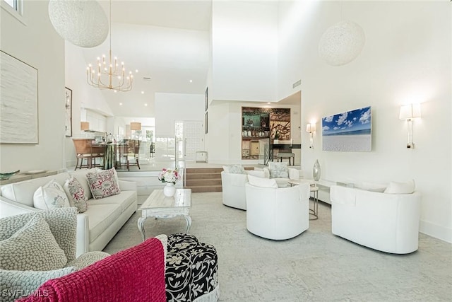 living room with a notable chandelier and a towering ceiling