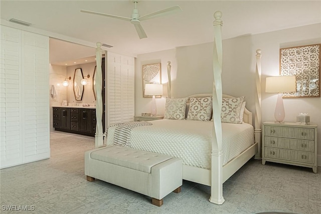 carpeted bedroom with ceiling fan and ensuite bathroom