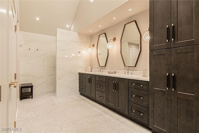 bathroom featuring vanity and vaulted ceiling