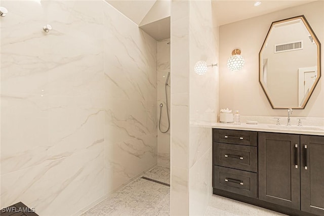 bathroom with vanity and tiled shower