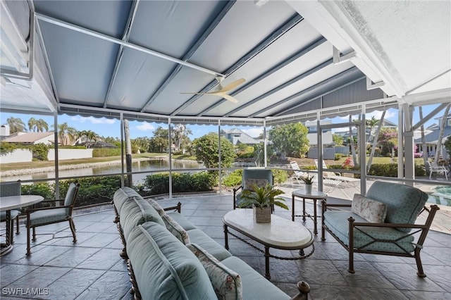 sunroom featuring a water view