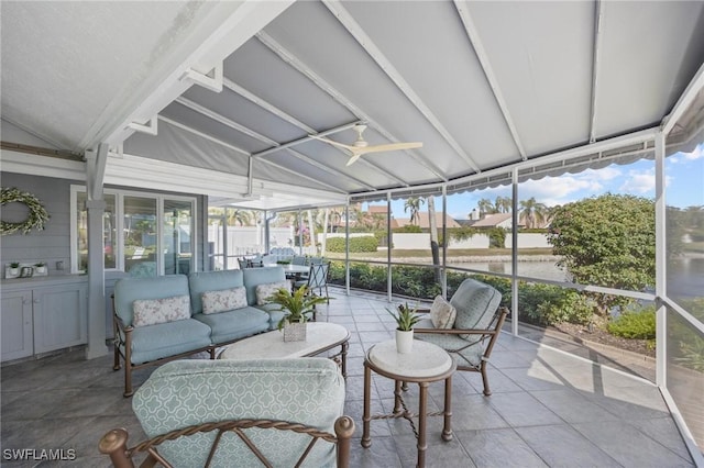 sunroom featuring vaulted ceiling, plenty of natural light, and ceiling fan