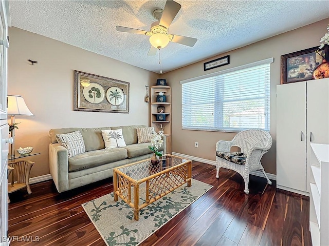 living room with ceiling fan, a textured ceiling, and dark hardwood / wood-style flooring