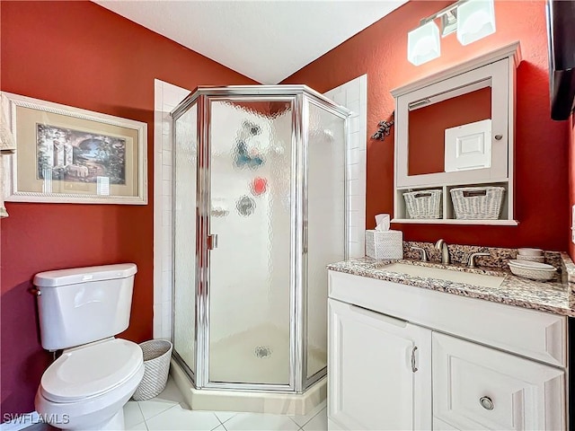 bathroom featuring toilet, vanity, tile patterned floors, and walk in shower