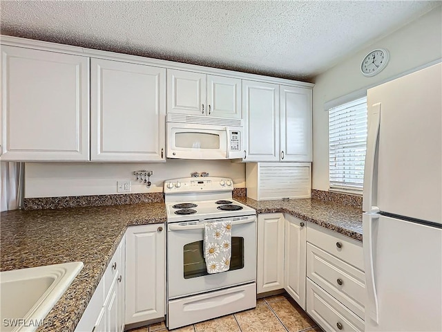 kitchen with white cabinetry, sink, a textured ceiling, and white appliances