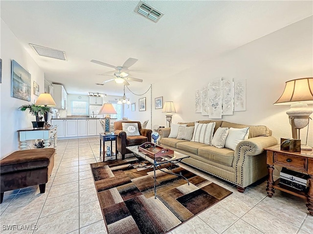 tiled living room featuring ceiling fan