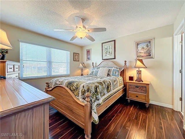 bedroom featuring ceiling fan, dark hardwood / wood-style floors, and a textured ceiling