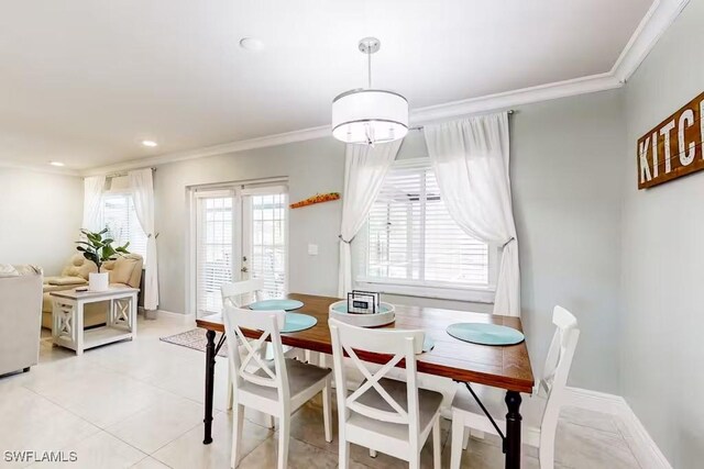 tiled dining space featuring crown molding