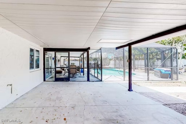 view of patio / terrace featuring a fenced in pool and glass enclosure