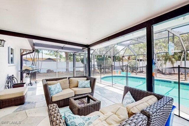 view of patio / terrace with an outdoor living space, area for grilling, a fenced in pool, and glass enclosure