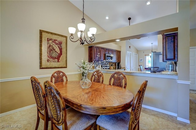 dining room with lofted ceiling and a notable chandelier