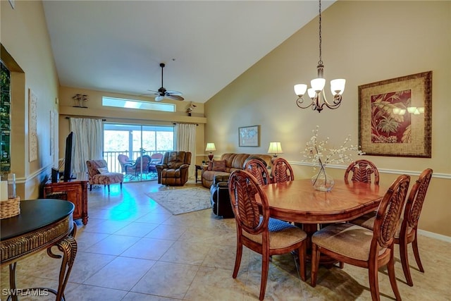 tiled dining area with ceiling fan with notable chandelier and high vaulted ceiling