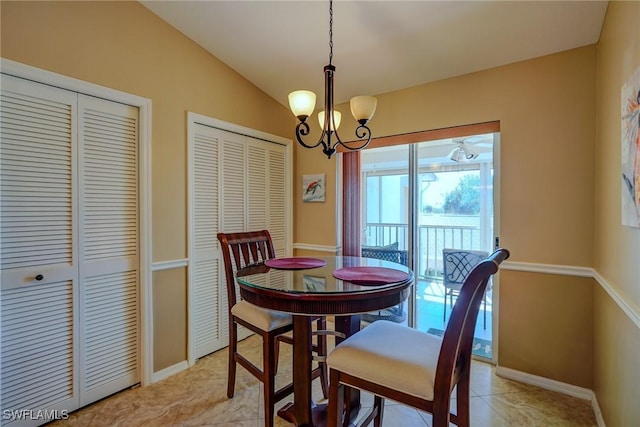 dining space featuring vaulted ceiling and a notable chandelier