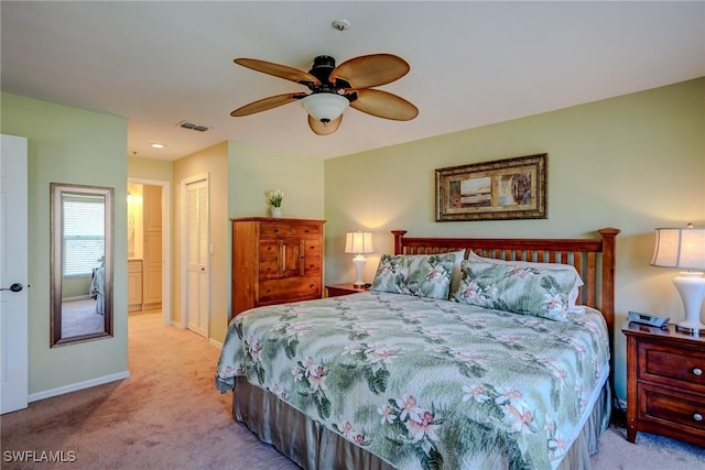 bedroom featuring ceiling fan, light colored carpet, and a closet