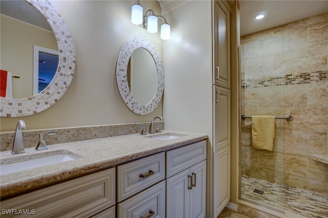 bathroom with vanity and a tile shower