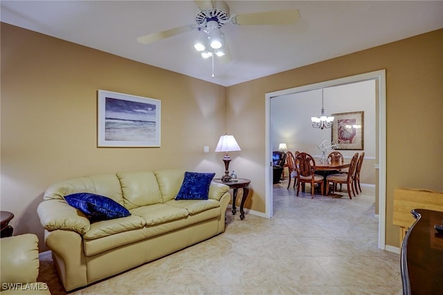 living room featuring ceiling fan with notable chandelier