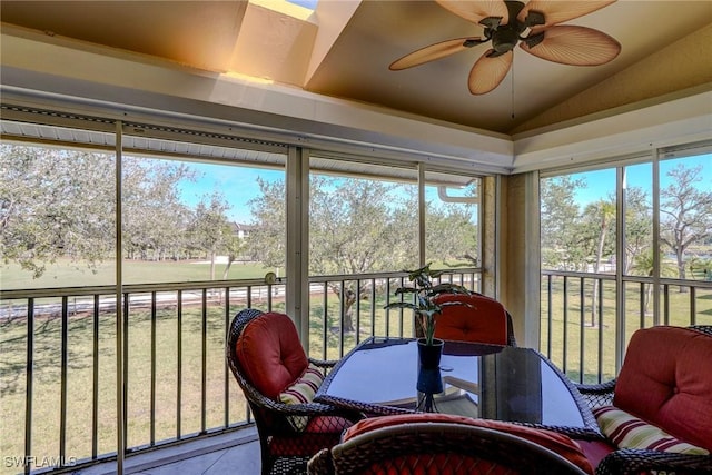 sunroom / solarium featuring lofted ceiling and ceiling fan