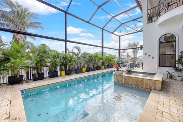 view of swimming pool featuring an in ground hot tub, a patio area, and glass enclosure