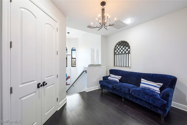 living area with dark hardwood / wood-style floors and a chandelier